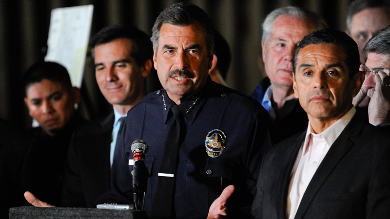 Los Angeles Police Department Chief Charles Beck flanked by Los Angeles Mayor Antonio Villaraigosa, right, answers questions during a news conference of the joint task force announcing the apprehension of a prime suspect Harry Burkhart in a series of 53 blazes in the Los Angeles Area, Monday, Jan. 2, 2012. (AP / Gus Ruelas)