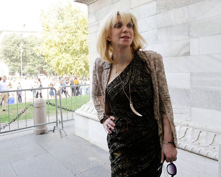 Singer Courtney Love poses for the photographers prior to the start of the Roberto Cavalli women's Spring-Summer 2012 fashion collection unveiled in Milan, Italy, Monday, Sept. 26, 2011. (AP / Antonio Calanni)