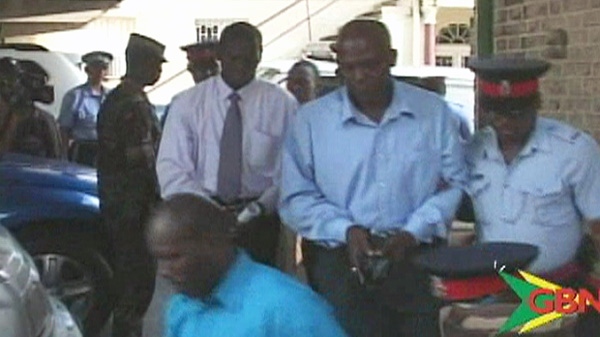 An image captured from GBN television footage shows some of the arrested officers being led into court on Tuesday, Jan. 3, 2011. (Photo courtesy Grenadan Broadcasting Network)
