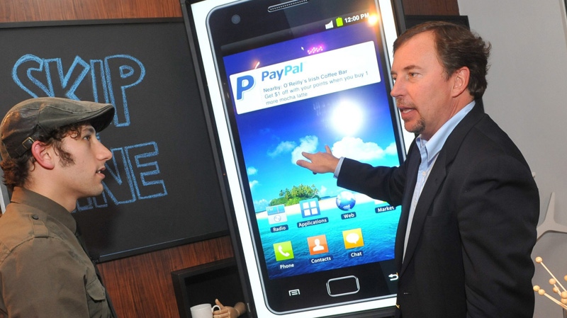 In this photograph taken by AP Images for PayPal, PayPal President Scott Thompson, right, demos upcoming technologies at the PayPal Shopping Showcase, Wednesday, Nov. 2, 2011, in New York. (Diane Bondareff/AP Images for PayPal)