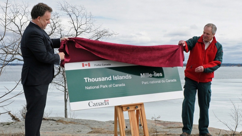 Mr. Gord Brown, Member of Parliament for Leeds-Grenville (left), and Mr. Jeff Leggo, Superintendent, Thousand Islands National Park, unveil the new park sign following the official name change of the park to 'Thousand Islands National Park of Canada,' Thursday, March 28, 2013, in Mallorytown, Ontario. The Canadian Press Images PHOTO/Parks Canada