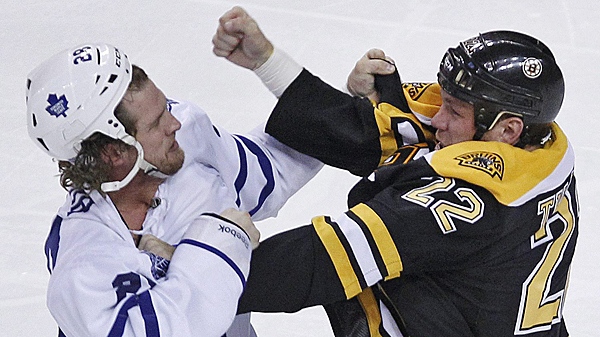 Boston Bruins left winger Shawn Thornton (22) throws a punch in a fight with Toronto Maple Leafs right winger Colton Orr, left, during the first period of an NHL hockey game in Boston on Thursday, Oct. 20, 2011. (AP Photo/Charles Krupa)