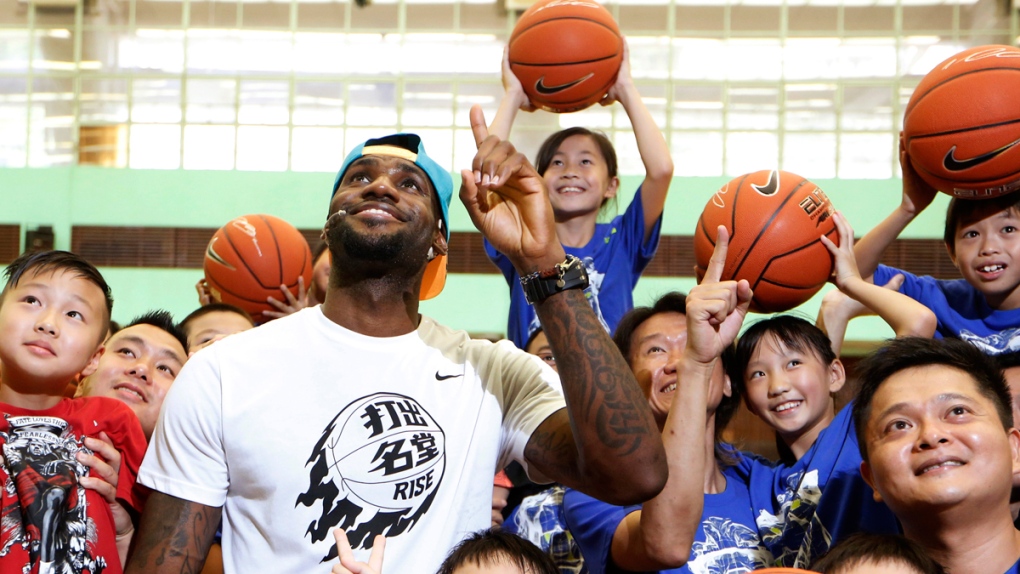 LeBron James poses with fans in Hong Kong
