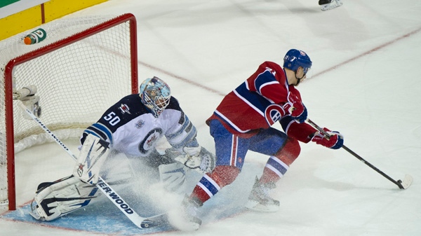 Montreal Canadiens' Lars Eller backhands a shot into the net past Winnipeg Jets goalie Chris Mason on a penalty shot for his fourth goal during third period NHL hockey action Wednesday, January 4, 2012 in Montreal. The Canadiens beat the Jets 7-3. THE CANADIAN PRESS/Paul Chiasson