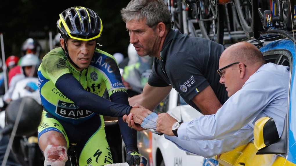 Spain's Alberto Contador gets assistance