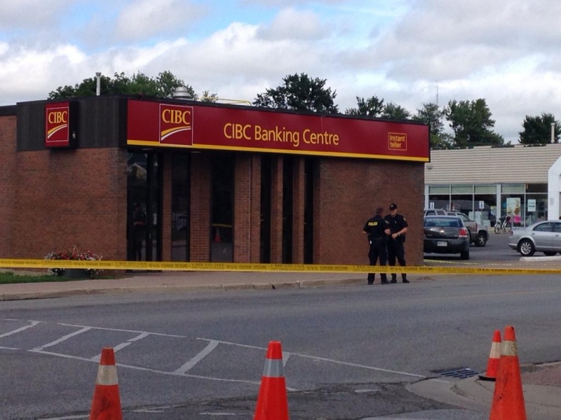 Police tape surrounds a CIBC bank branch after a reported armed robbery in Petrolia, Ont. on Wednesday, July 23, 2014. (Cristina Howorun / CTV London)