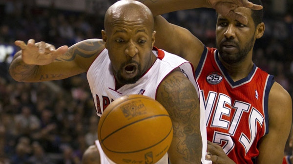 Toronto Raptors guard Anthony Carter, left, and New Jersey Nets forward Shawne Williams (7) battle for a rebound during first half NBA action in Toronto on Friday Jan. 6, 2012. (AP Photo/The Canadian Press, Frank Gunn)