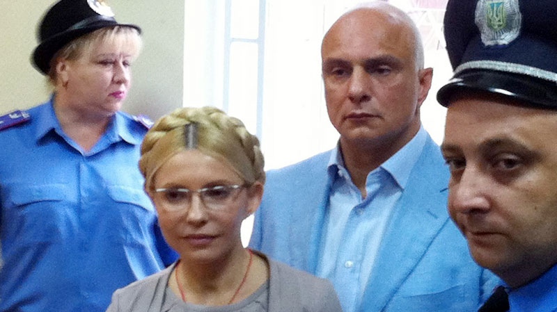 Ukraine's former Prime Minister Yulia Tymoshenko seen inside the court hearing room with her husband Oleksandr  nearby on the right, in Kiev, Ukraine, on Aug. 11, 2011. (AP / Olexander Prokopenko, Pool)