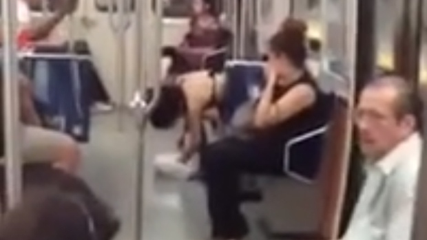 Woman appears to be eating raw bird on subway