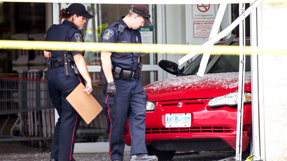 Police examine the crash at Costco in London, Ont.