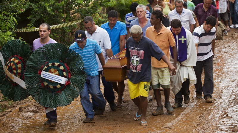 Relatives carry the coffins of a family that was killed by a mudslide to the cemetery in Jamapara, Rio de Janeiro state, Brazil, Tuesday Jan. 10, 2012. 