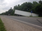 A transport truck is in the ditch after a collision with a van on Highway 24 on Tuesday July 29, 2014.