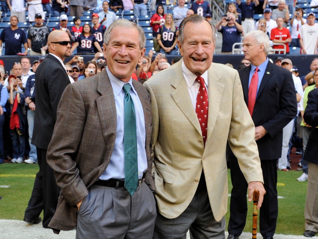 George W. Bush with his father at football game 