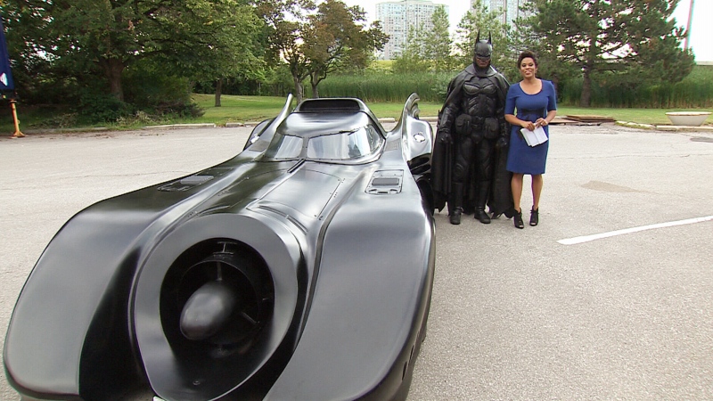 Brampton Batman poses with CTV's Canada AM host Marci Ien in Toronto on Thursday, July 31, 2014. 