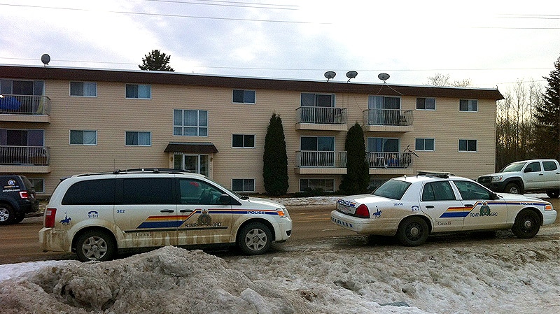 RCMP vehicles outside an apartment complex in Onoway, AB. where a man was shot and killed by officers after approaching them with an edged weapon on Wednesday, January 12, 2012.