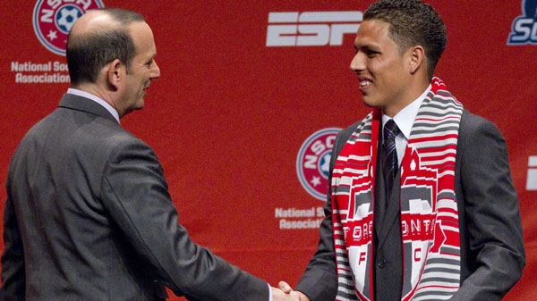 Major League Soccer commissioner Don Garber, left, welcome Luis Silva, right, to the stage after he was announced as the number four player taken in the first round by Toronto FC during the 2012 Major League SoccerSuper Draft at the Kansas City Convention Center on Thursday, Jan. 12, 2012, in Kansas City, Mo. (AP Photo/The Kansas City Star, Shane Keyser) 