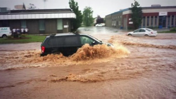 A van trudging through floodwaters in Burlington.