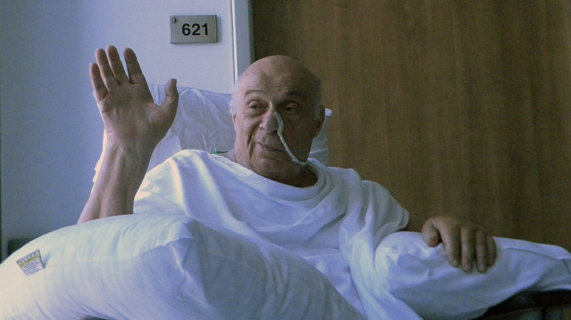 In this June 14, 2011 file photo, Rauf Denktash, the former Turkish Cypriot leader, waves in a hospital in Nicosia, Cyprus. Denktsh whose determined pursuit of a separate state for his people and strong opposition to the divided island's reunification defined a political career spanning six decades, died in Nicosia, Cyprus, Friday, Jan. 13, 2012.