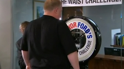 Mayor Rob Ford weighs in for his 'Cut the Waist' challenge at city hall in Toronto, Monday, Jan. 16, 2012.