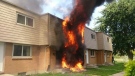 Large flames and black smoke exit a townhouse at 2667 Scarsdale Road in Windsor, Ont. on Thursday, Aug. 7, 2014. (Frank Krawl)
