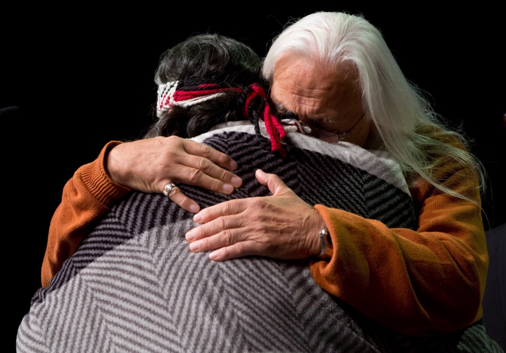 Residential school survivor hugs an elder