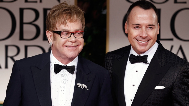 Elton John and David Furnish arrive at the 69th Annual Golden Globe Awards Sunday, Jan. 15, 2012, in Los Angeles. (AP / Matt Sayles)