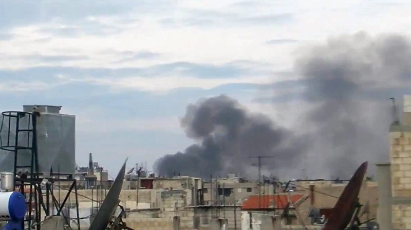 This image from amateur video made available by Shaam News Network on Friday, Jan. 13, 2012, purports to smoke billowing after explosions in Homs, Syria.(AP Photo/Shaam News Network via APTN)