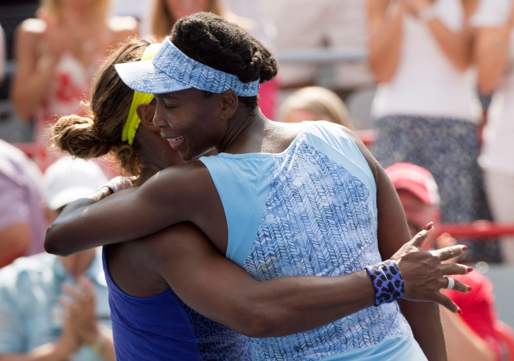 Venus Williams hugs Serena Williams at Rogers Cup