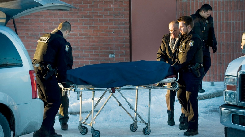 The body of a former Montreal police officer is removed from the Chateauneuf Hotel in Laval, Que., Wednesday, January 18, 2012. A former Montreal police officer who allegedly tried to sell confidential information to the Mafia has committed suicide, according to several reports. THE CANADIAN PRESS/Graham Hughes