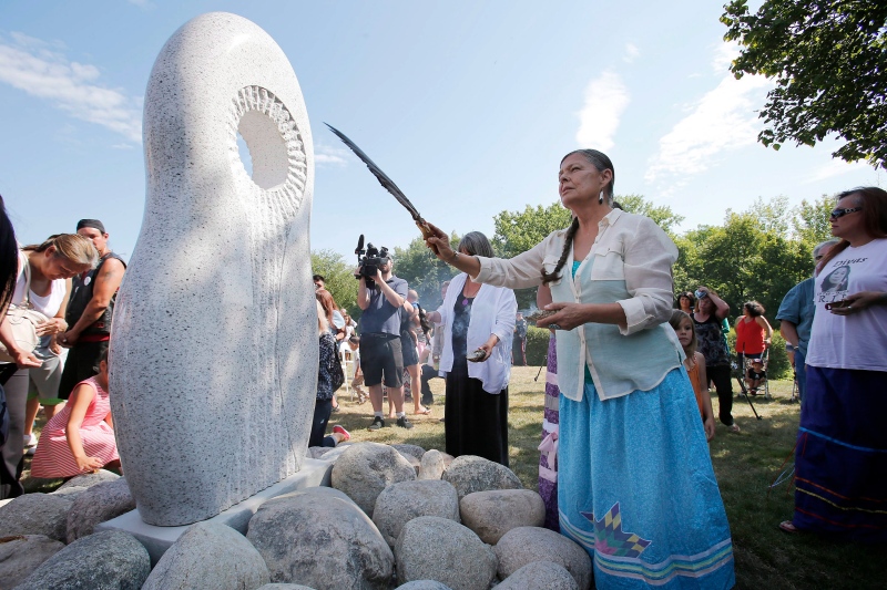 A monument honouring Manitoba's missing and murdered women and girls is unveiled and blessed in Winnipeg on Tuesday, August 12, 2014. (John Woods / THE CANADIAN PRESS)