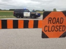Police block off a road near Centralia, Ont., as they search for a two-year-old girl who went missing in a cornfield north of London, Ont., Wednesday, Aug. 13, 2014.