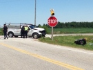 Essex OPP officers examine the scene of a collision near Comber, Ont., where a motorcyclist died in a two vehicle collision on Wednesday, Aug. 13, 2014. (Rich Garton/ CTV Windsor) 