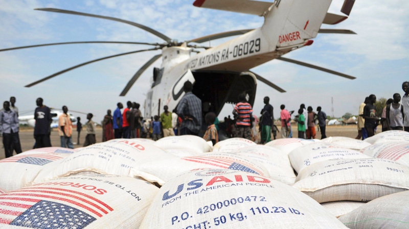 Relief food of the World Food Program is offloaded in Pibor, South Sudan, Thursday, Jan. 12, 2012. (AP / Michael Onyiego)