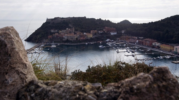 In this photo taken on Jan. 18, 2012 a view of Porto Ercole, along the Argentario coast, Italy. A half-million gallons (2,400 tons) of fuel inside the capsized Costa Concordia cruiser liner risk polluting some of the Mediterranean's most pristine sea, where dolphins are known to chase playfully after sailboats and where fishermen's catches are so prized, wholesale fishmongers come from across Italy to scoop up cod, lobsters, scampi, 90-kilo (200-pound) swordfish and other delicacies for pricey markets. (AP Photo/Angelo Carconi)