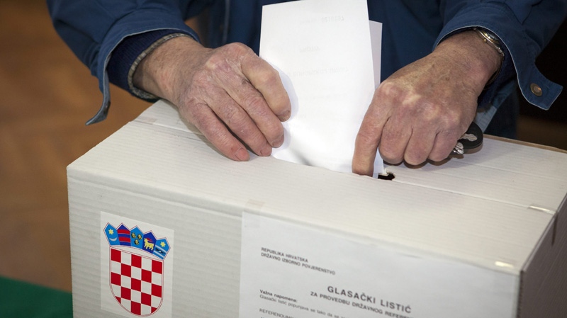 A voter casts his ballot at a polling station in Zagreb, Croatia, Sunday, Jan. 22, 2012.  (AP Photo/Darko Bandic)