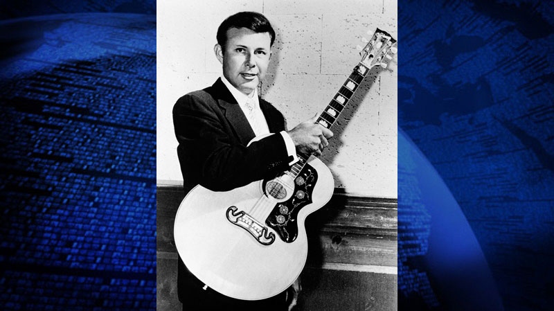 FILE - In this in 1958 file photo Country singer Jim Reeves poses with his Gibson J-200 guitar on the "Country Music Jubilee." A trial over how music royalties of the late country singer "Gentleman" Jim Reeves should be split is set to begin this week. Reeves was a country music sensation when he died nearly 50 years ago in a plane crash at the age of 39.