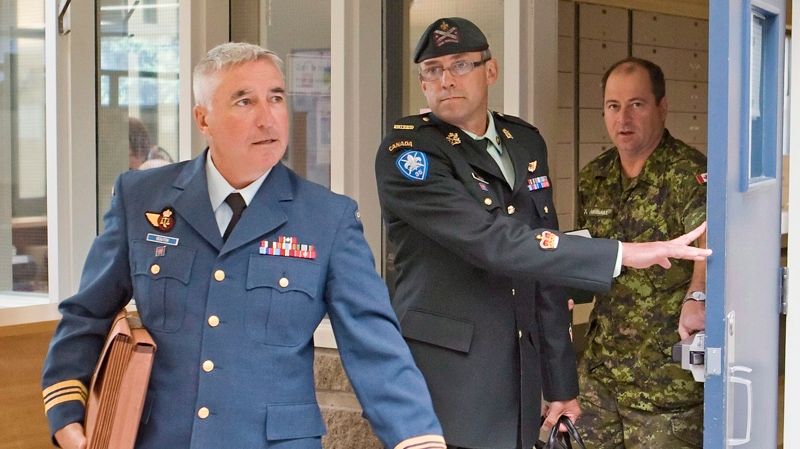 Warrant officer Andre Gagnon, centre, walks to tes