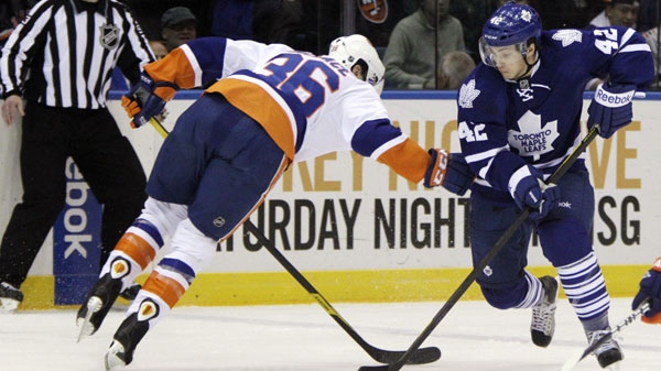 New York Islanders right wing Tim Wallace (36) pressures Toronto Maple Leafs center Tyler Bozak (42) in the first period of their NHL hockey game in Uniondale, N.Y., Tuesday, Jan. 24, 2012. (AP Photo/Kathy Willens)