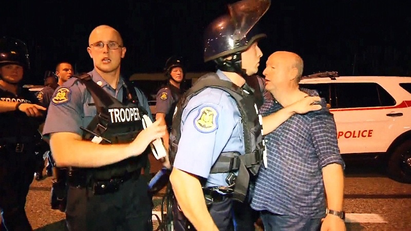 CTV's Tom Walters is arrested at a protest after attempting to question Highway Patrol Capt. Ron Johnson, in Ferguson, Mo., on Aug. 20, 2014.