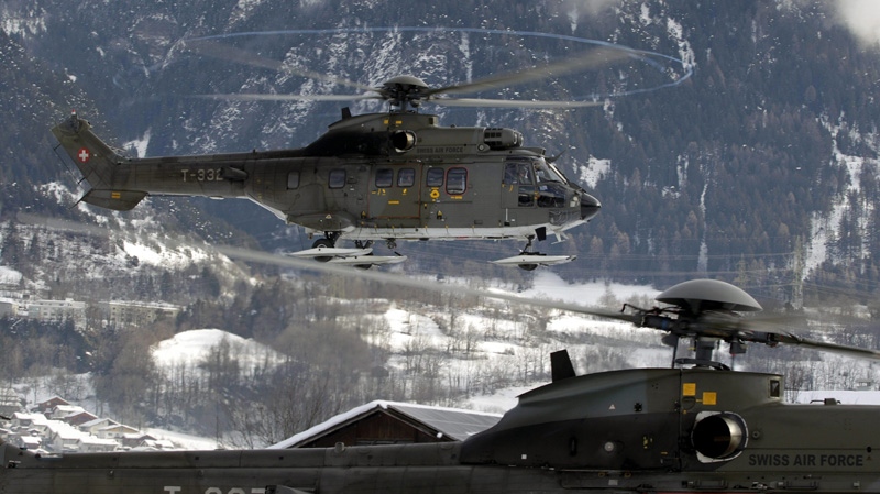 Swiss Air Force helicopters practice during security preparations for the upcoming World Economic Forum (WEF) in Davos, Switzerland, Monday Jan. 23, 2012.  (AP Photo/Keystone/Arno Balzarini)