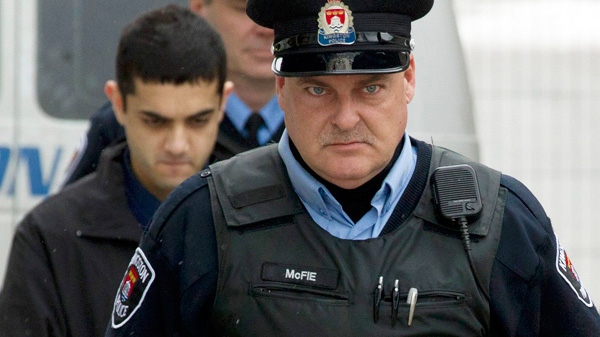 Hamed Mohammed Shafia is escorted into the Frontenac County courthouse in Kingston, Ontario on Wednesday, Jan. 25, 2012. (Frank Gunn / THE CANADIAN PRESS)