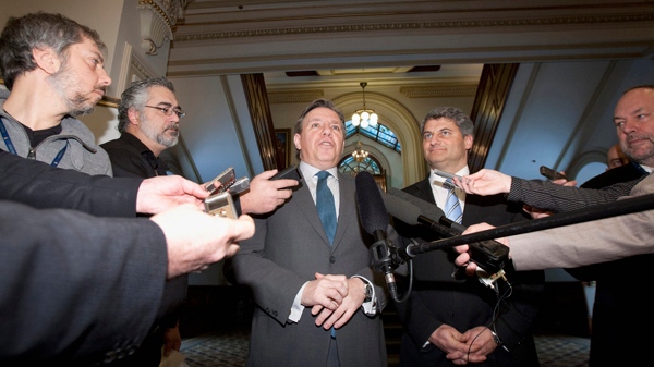 Francois Legault, centre left, leader of the Coalition Avenir Quebec, responds to questions following a caucus meeting. (THE CANADIAN PRESS/Jacques Boissinot)