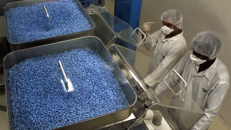 Egyptian technicians at Pfizer factory in Cairo sort thousands of Viagra pills on a packing machine to be marketed in Egypt's pharmacies, June 18, 2002. THE CANADIAN PRESS/AP-Amr Nabil