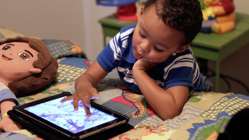 Frankie Thevenot, 3, plays with an iPad in his bedroom at his home in Metairie, La. on Oct. 21, 2011. (Gerald Herbert / AP)