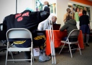 A man with crutches signs up for health coverage, Monday, March 31, 2014, in New Britain, Conn. (AP/Jessica Hill)
