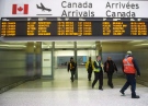 Air Canada workers walk at Pearson International Airport in Toronto on March. 8, 2012. (Nathan Denette/THE CANADIAN PRESS)