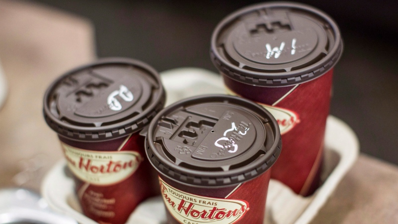 Cups of coffee sit on a counter in a Tim Hortons in Oakville, Ontario on Monday September 16, 2013. (Chris Young / THE CANADIAN PRESS)