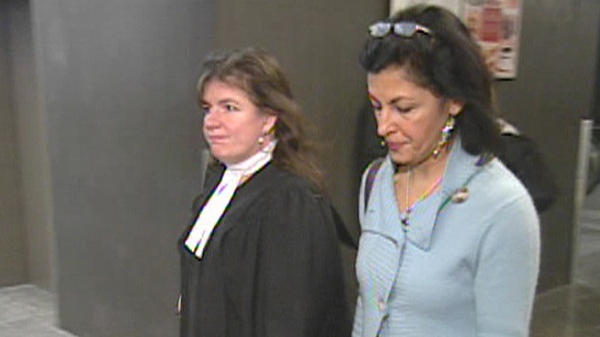 Mitra Javanmardi and her lawyer walk through the Montreal courthouse (Jan. 26, 2012)