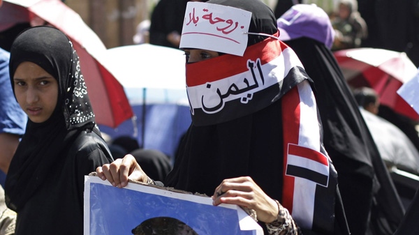 A female protestor holds a defaced picture of Yemen's President Ali Abdullah Saleh during a demonstration demanding the prosecution of Saleh in Sanaa, Yemen, Friday, Jan. 27, 2012