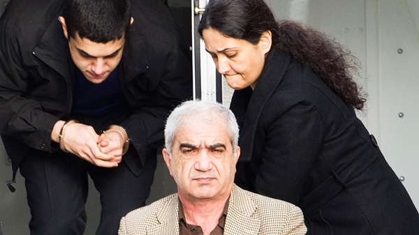 Mohammad Shafia, front, Tooba Yahya, right, and their son Hamed Shafia, left, are escorted at the Frontenac County courthouse in Kingston, Ontario on Saturday, January 28, 2012. 